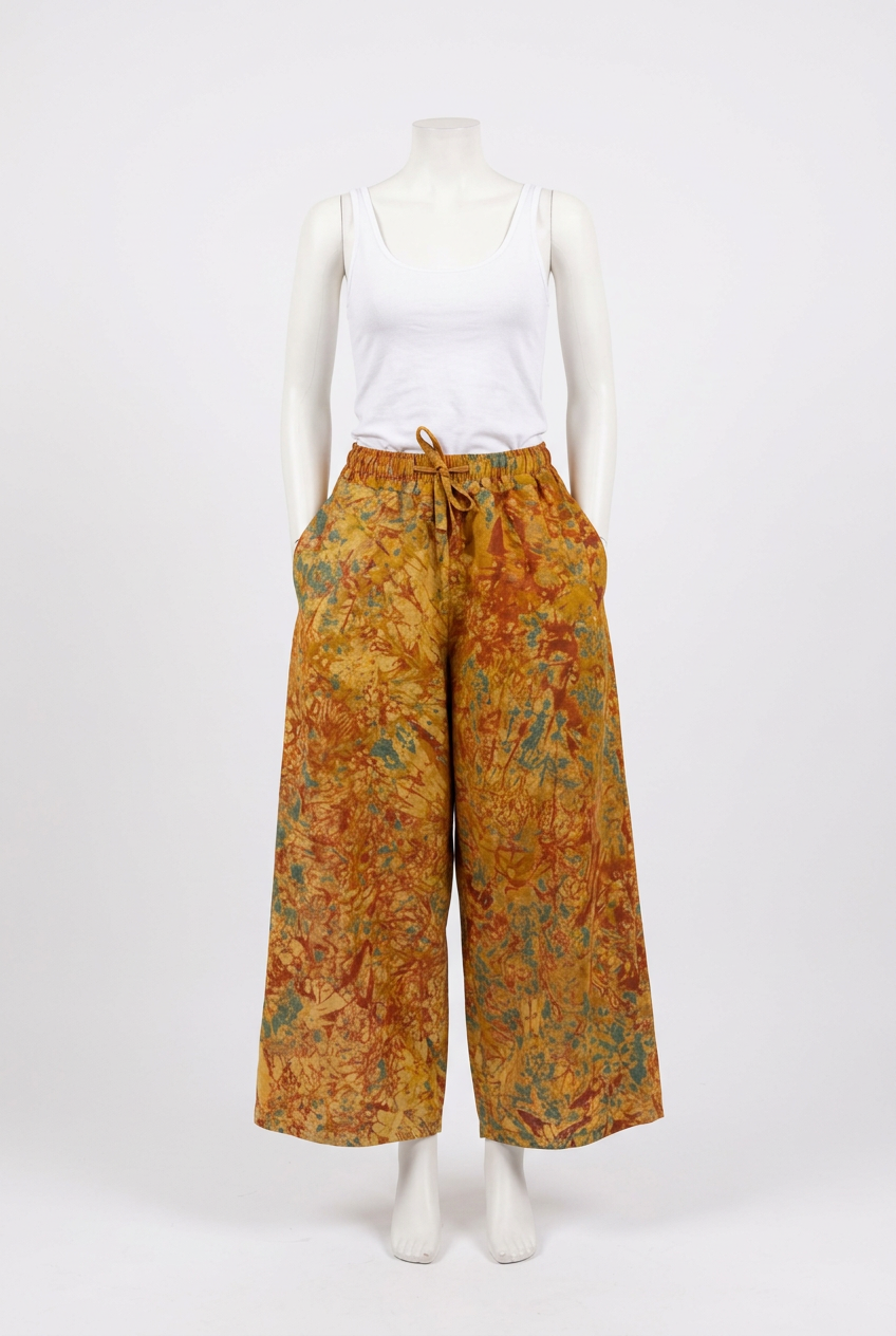 Mustard Batik Wide-Leg Trousers on a mannequin
